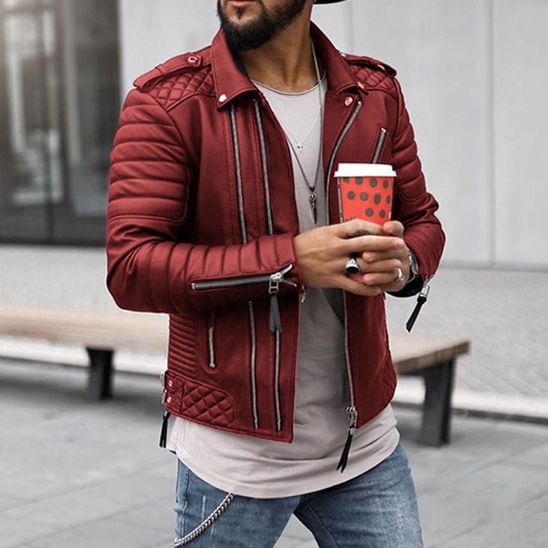 Man wearing a red jacket holding a red coffee cup with a polka dot pattern.
