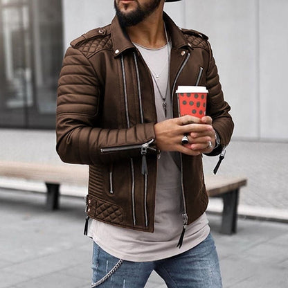 Man wearing a brown leather jacket holding a red coffee cup outdoors.