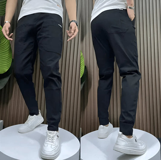 Two views of a person wearing black pants and white sneakers against a neutral background.