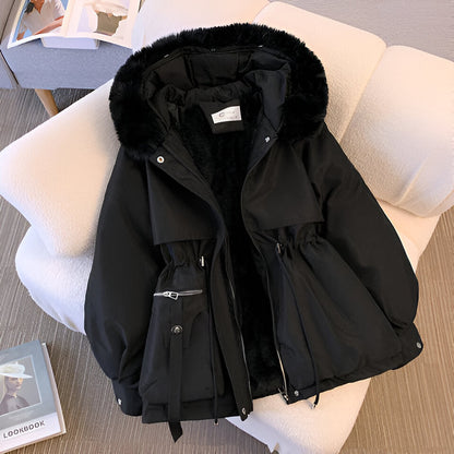 Black winter jacket with fur hood on a chair