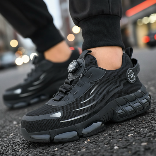 Black sneakers with a textured sole worn on a blurred street background