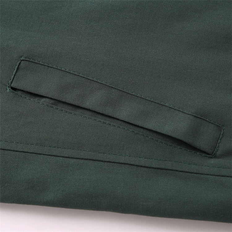 Close-up of a green fabric pocket on a garment.