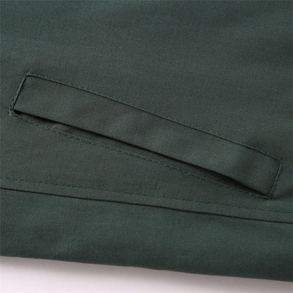 Close-up of a green fabric pocket on a garment.