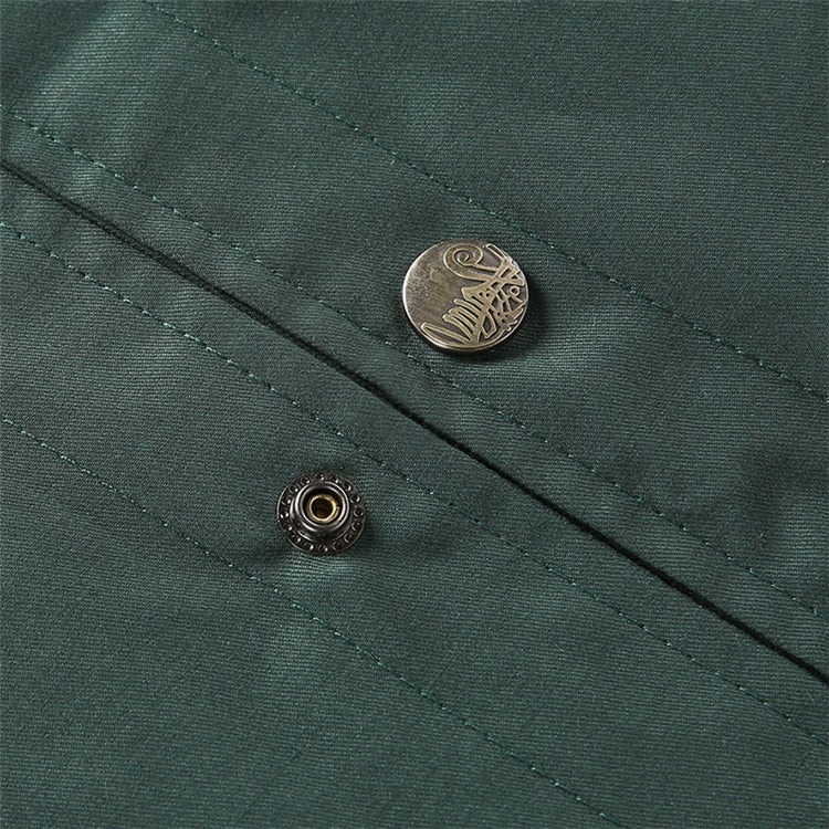 Close-up of a green fabric with buttons on a textured background