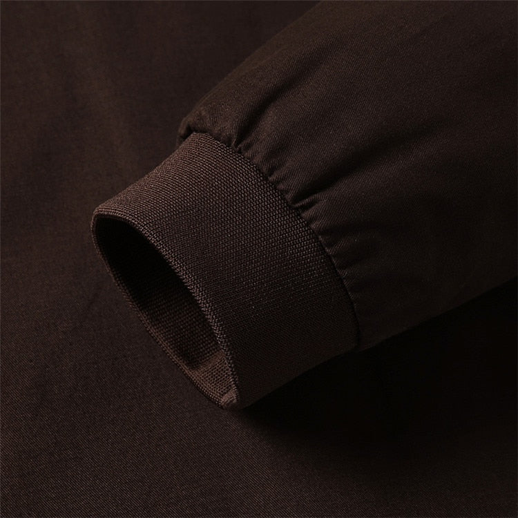 Close-up of a dark brown fabric texture on a matching background