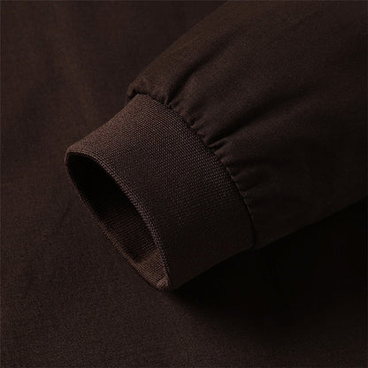 Close-up of a dark brown fabric texture on a matching background