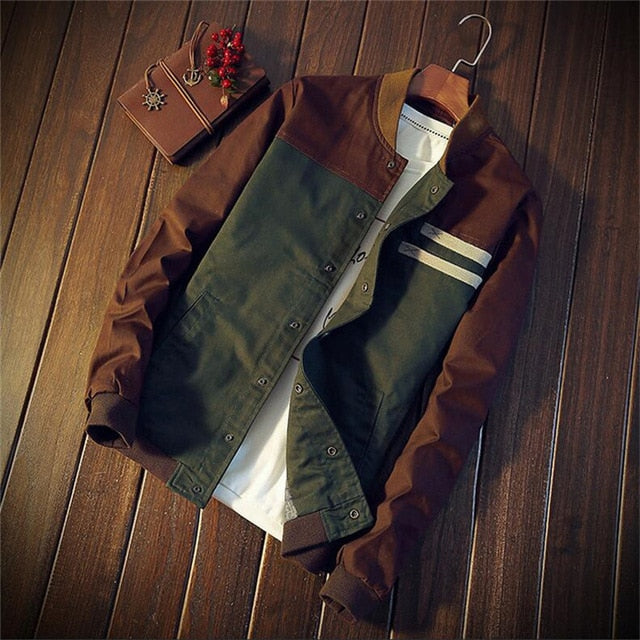 Two jackets, one green and one brown, on a wooden surface.