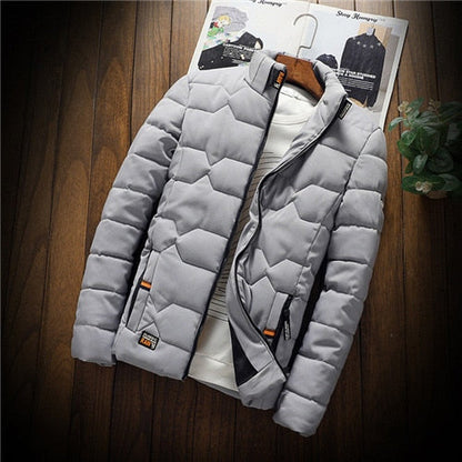 Gray puffer jacket on a wooden surface with a magazine underneath