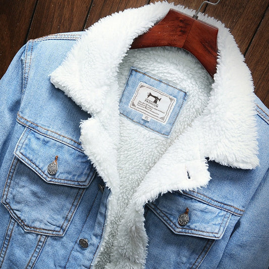 Blue denim jacket with white sherpa lining on a wooden surface