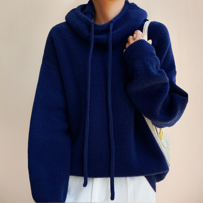 Person wearing a blue turtleneck sweater