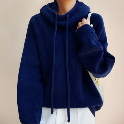 Person wearing a blue turtleneck sweater
