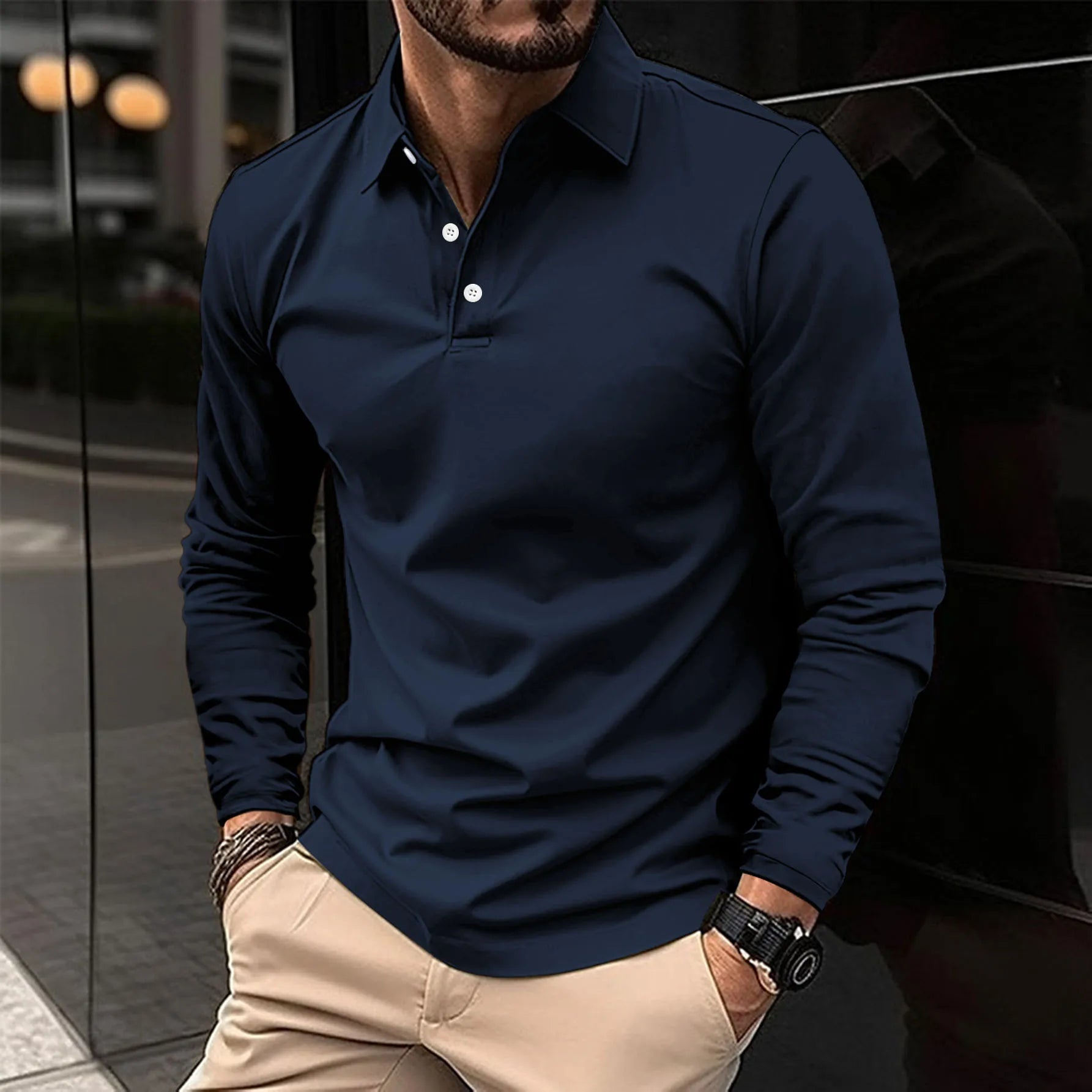 Man wearing a navy blue long-sleeve polo shirt with beige pants.