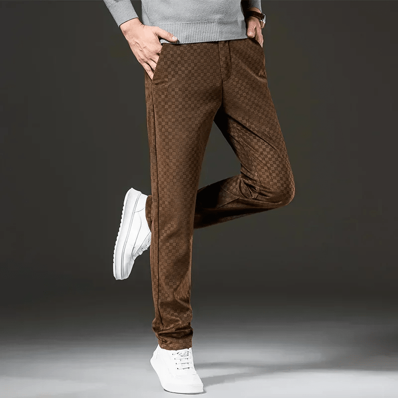 Brown checkered pants worn by a person on a dark background