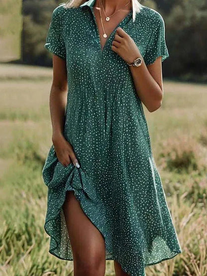 Woman wearing a green polka dot dress in a natural setting