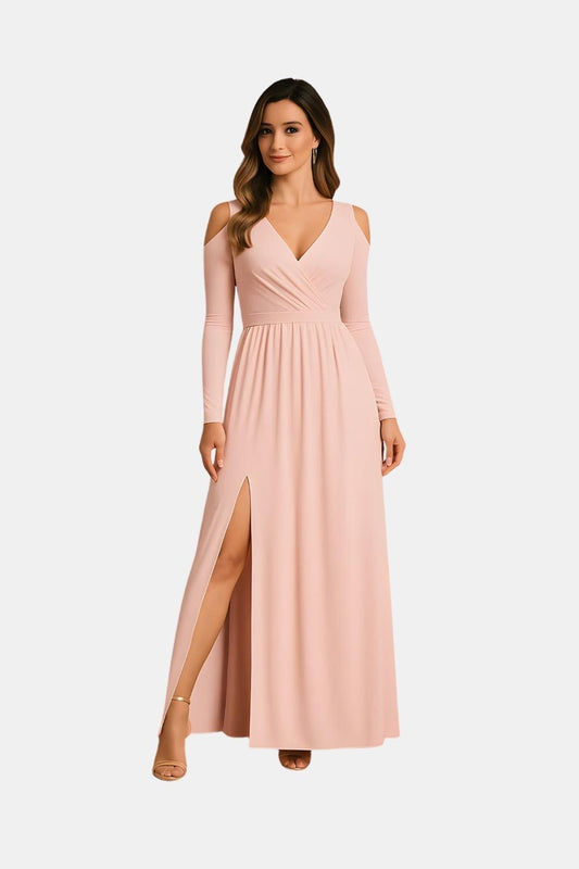 Woman wearing a long-sleeve pink dress with a slit on a white background