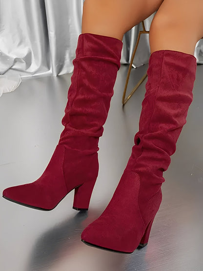 Red knee-high boots on a neutral background