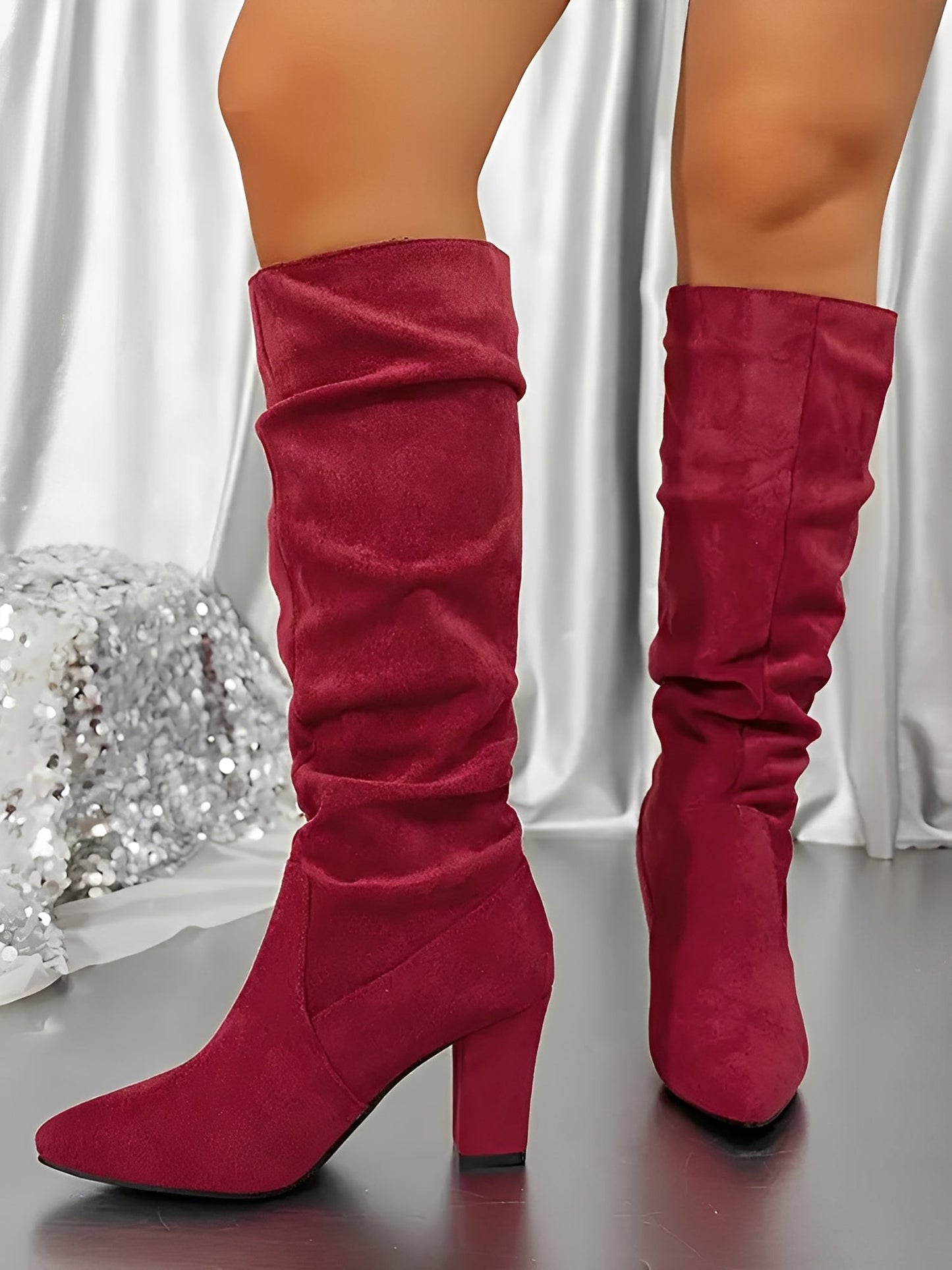 Red knee-high boots on a neutral background