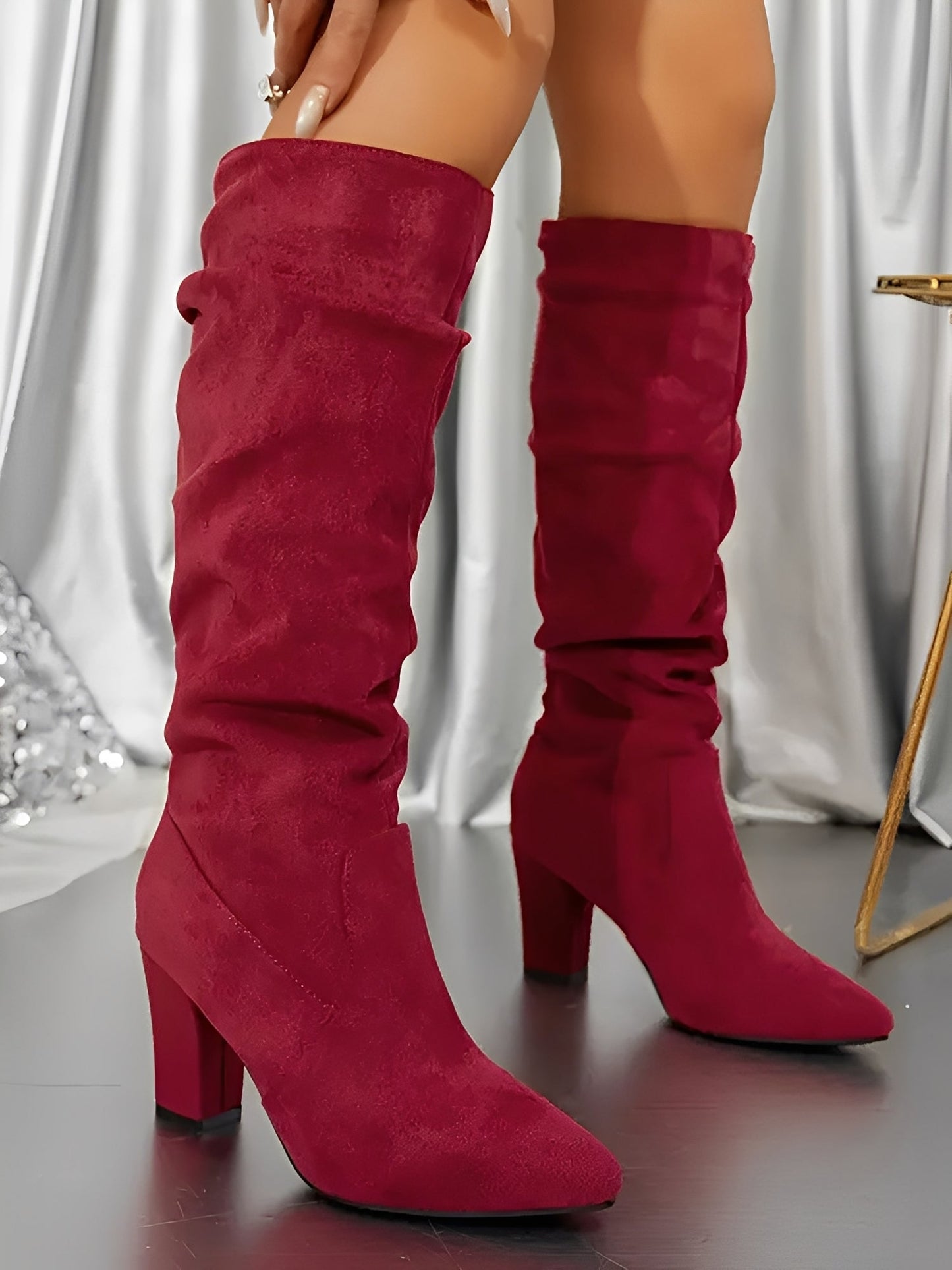 Red knee-high boots on a neutral background