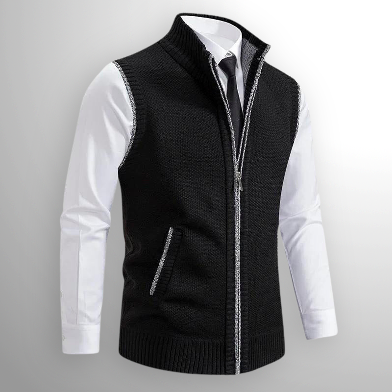 Black zip-up vest over a white shirt on a gray background
