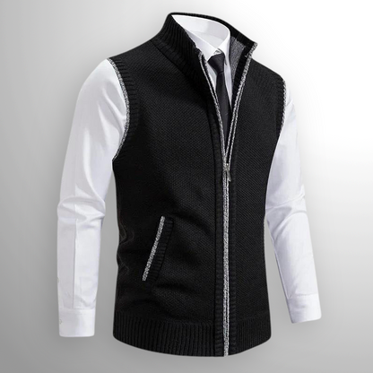 Black zip-up vest over a white shirt on a gray background