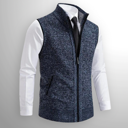 Blue knitted vest over a white shirt with a gray background
