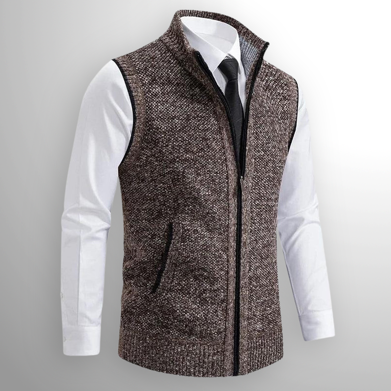 Brown knitted vest over a white shirt with a gray background