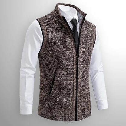 Brown knitted vest over a white shirt with a gray background