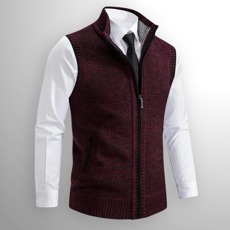 Maroon knitted vest over a white shirt with a gray background