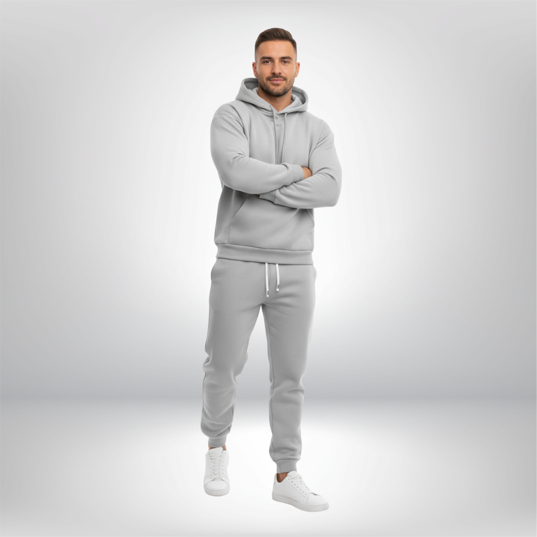 Man wearing a gray tracksuit on a light gray background
