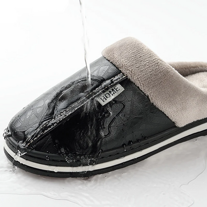 Black slipper with a visible brand label on a white background