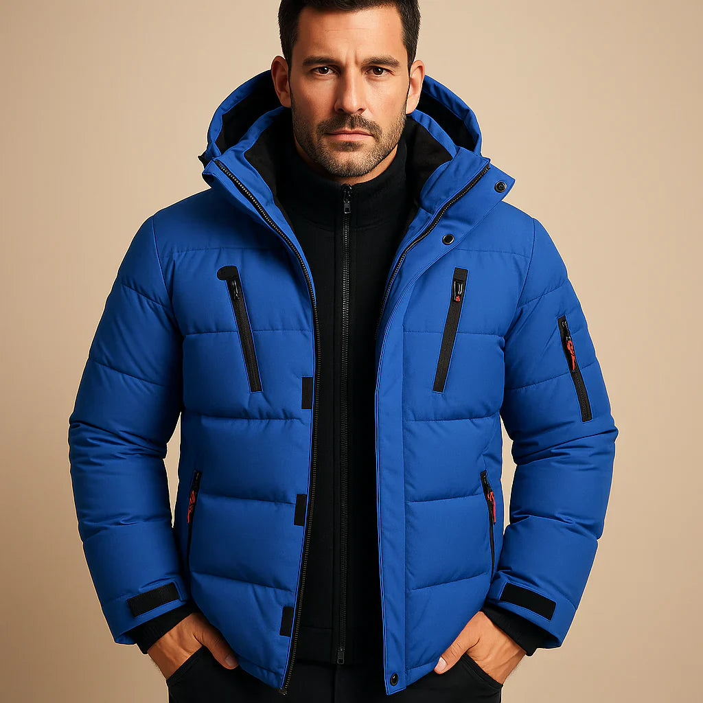 Man wearing a blue puffer jacket on a beige background