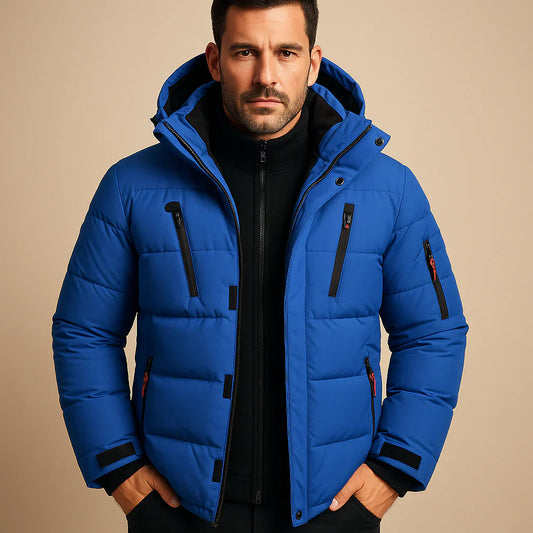 Man wearing a blue puffer jacket on a beige background