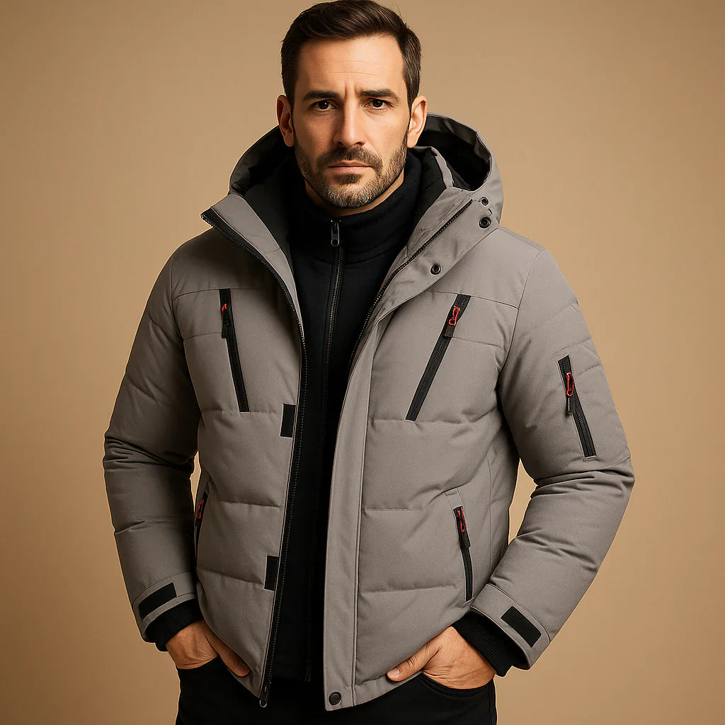 Man wearing a gray quilted jacket on a beige background