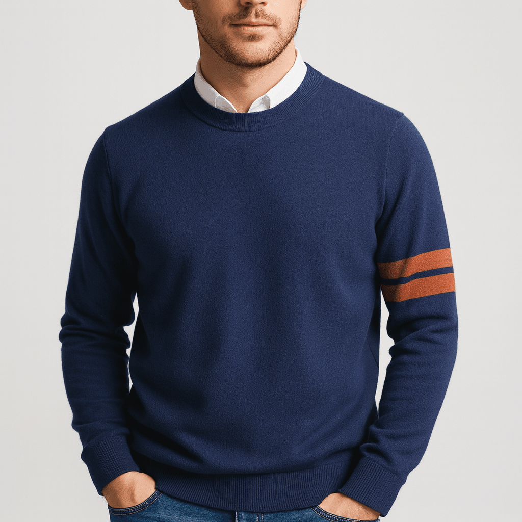 Man wearing a navy blue sweater with orange stripes on a light gray background