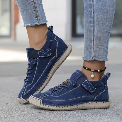 Blue sneakers worn with light blue jeans on a blurred background