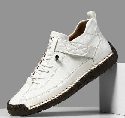 White sneaker with brown sole on a gray background