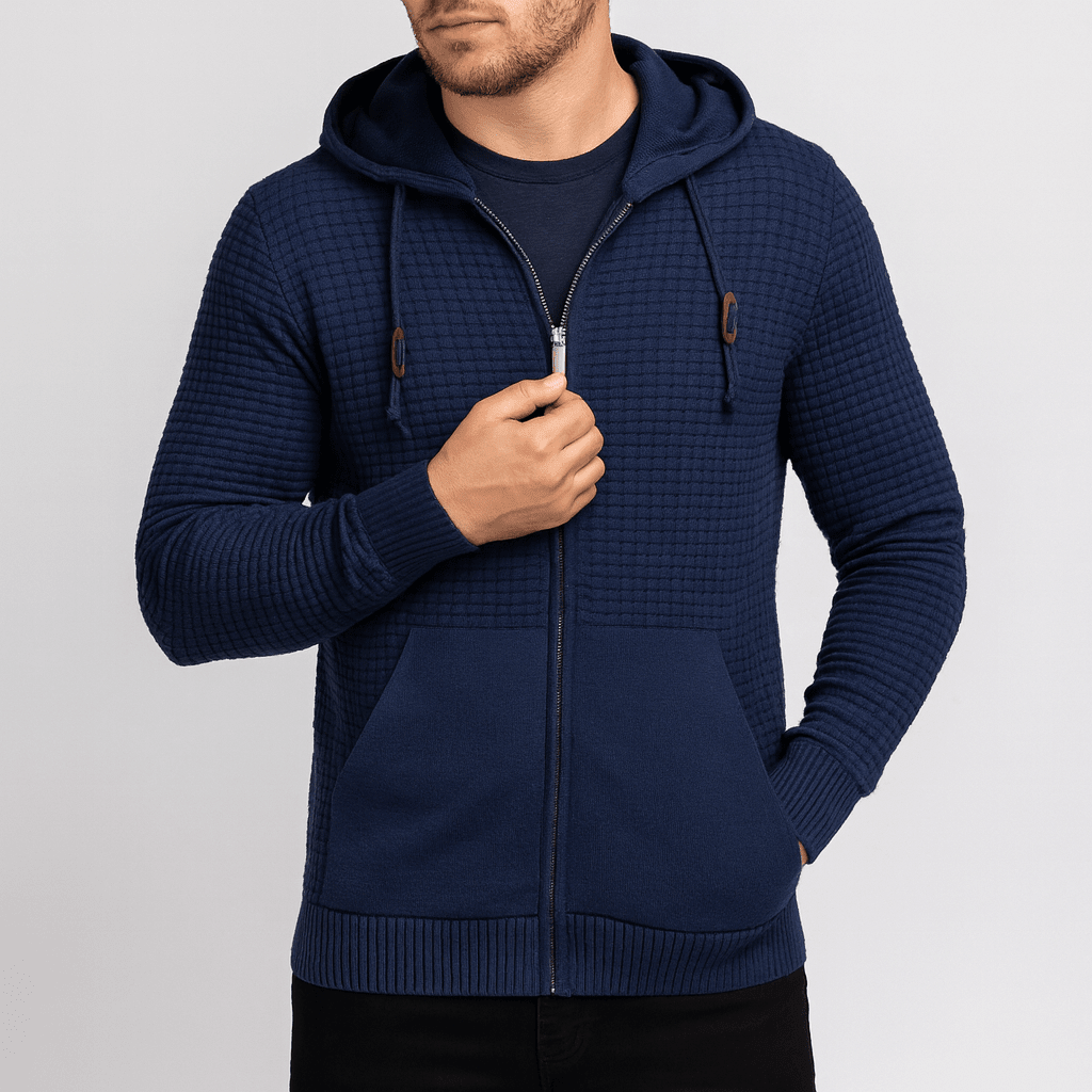 Man wearing a navy blue textured hoodie on a light gray background