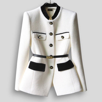 White blazer with black accents on a gray background