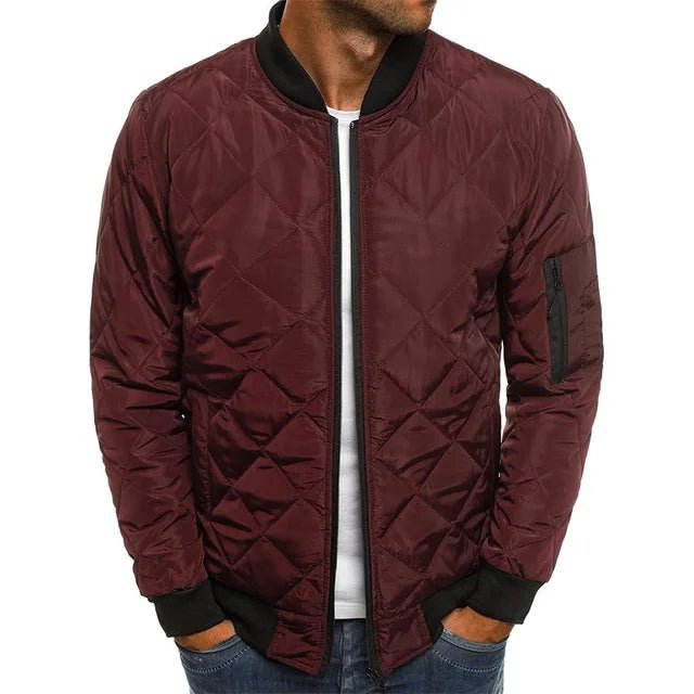 Maroon quilted jacket with black accents on a white background