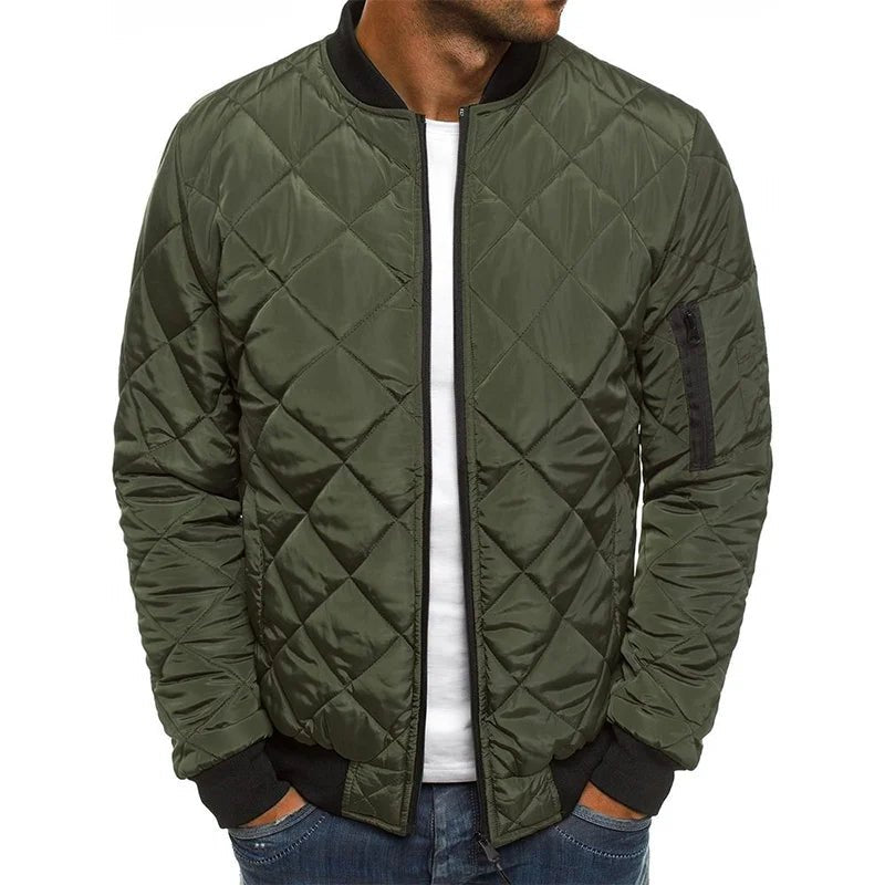 Green quilted jacket worn by a person on a white background