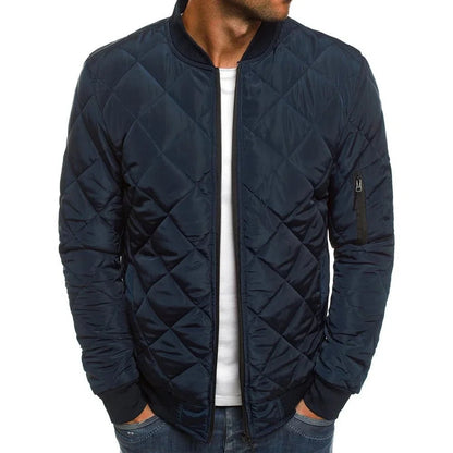 Navy quilted jacket worn by a person on a white background