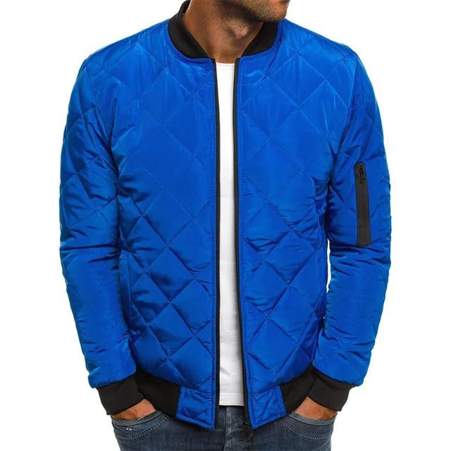Blue quilted jacket worn by a person on a white background