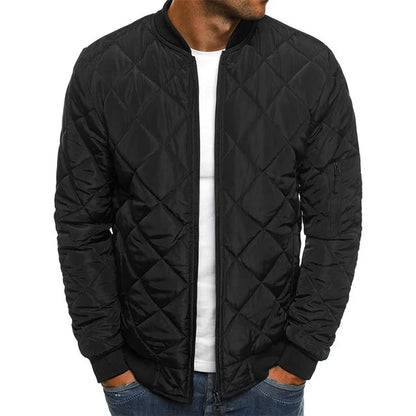 Black quilted jacket worn by a person on a white background