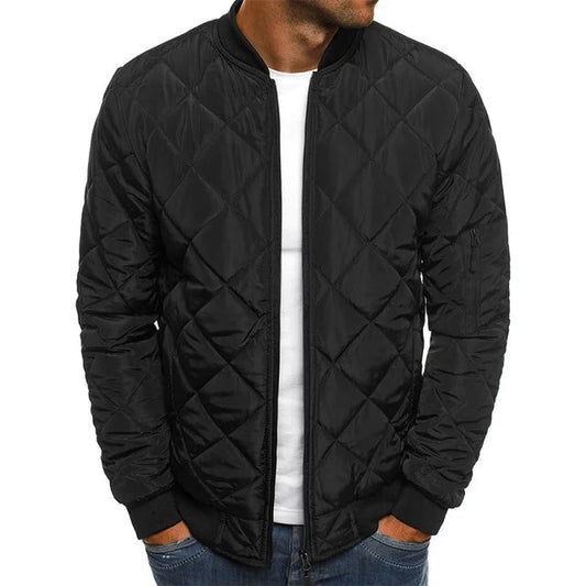 Black quilted jacket worn by a person on a white background
