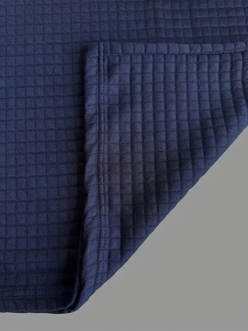 Navy blue textured blanket on a gray background