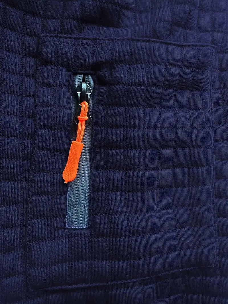 Close-up of a navy blue quilted jacket with an orange zipper