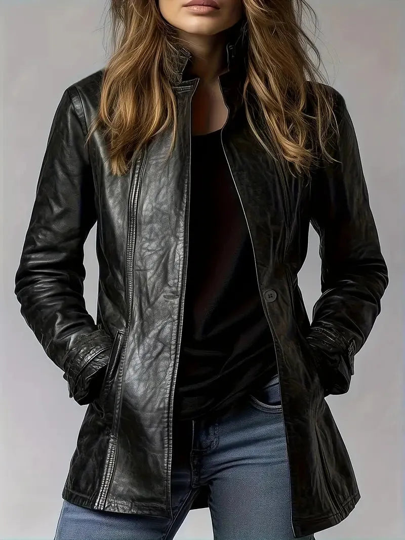 Person wearing a black leather jacket on a plain background