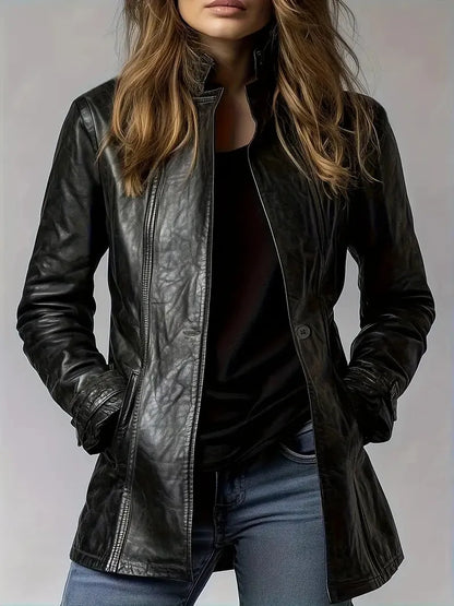 Person wearing a black leather jacket on a plain background