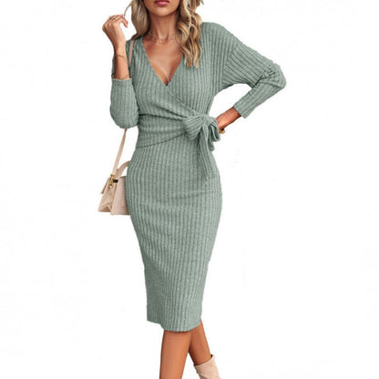 Woman wearing a green ribbed dress with a white background