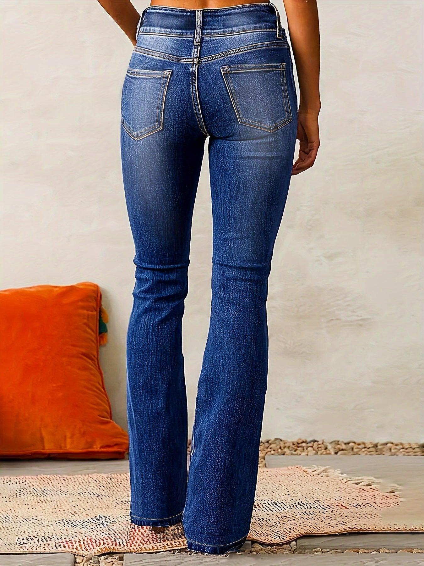 Blue jeans worn by a person on a neutral background
